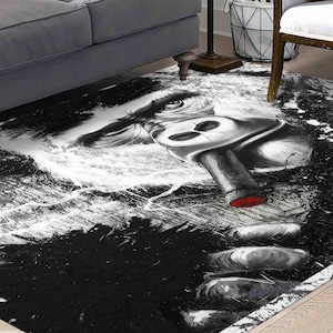 May include: Black and white rug with a graphic design of a gorilla's face with a red cigar in its mouth.
