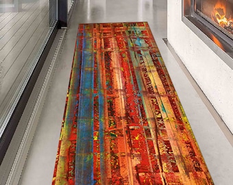 May include: Abstract runner rug with a colorful design of red, orange, yellow, blue, and green stripes. The rug is made of a soft, durable material and is perfect for adding a touch of modern style to any room.