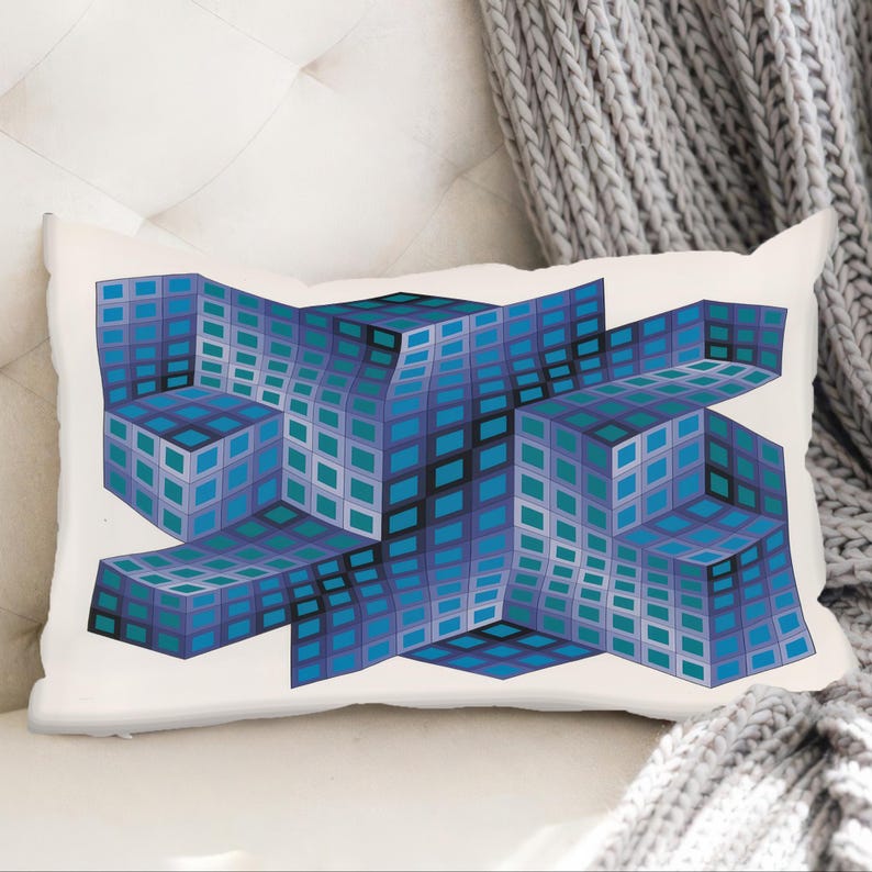 Op de afbeelding: Rechthoekig kussen met een geometrisch ontwerp. Het kussen heeft een herhalend patroon van blauwe en turquoise vierkanten, gerangschikt in een 3D-kubusachtige structuur tegen een witte achtergrond. Het ontwerp heeft een moderne, abstracte esthetiek.