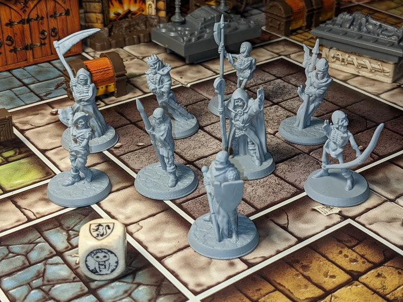 May include: A set of nine gray plastic miniature figures of skeletons and undead creatures, including a reaper, a skeleton archer, and a skeleton warrior. The figures are arranged on a game board with a gray and white dice in the foreground.