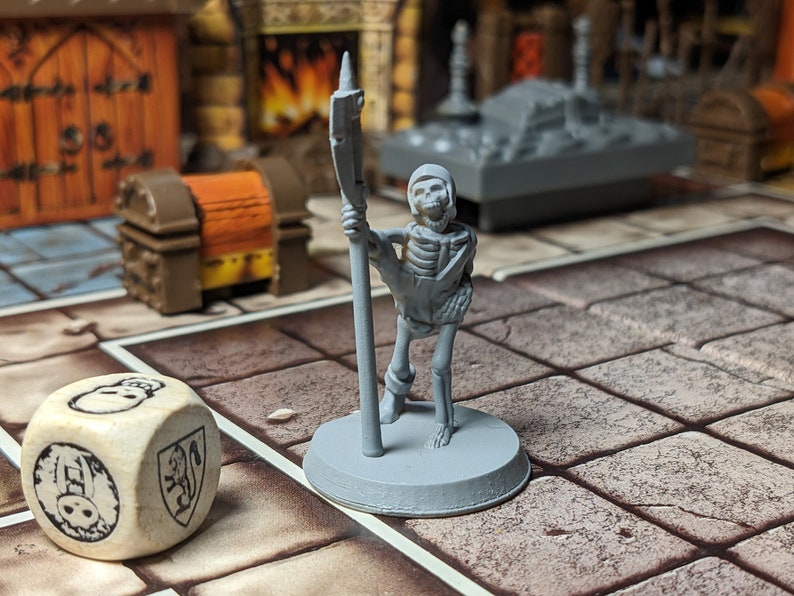 May include: A gray plastic miniature skeleton figure holding a spear, standing on a gray base. The figure is on a brown and white tiled surface.