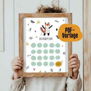 Puede incluir: Un gráfico imprimible con una ilustración de un zorro y el texto "Ich schaffe das!" (¡Lo consigo!). El gráfico tiene 25 círculos para marcar el progreso, con las palabras "Weiter so!" (¡Sigue así!) y "Geschafft!" (¡Hecho!) en la parte inferior.