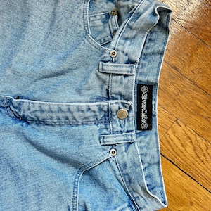 May include: Light blue denim shorts with a Silverlake label. The shorts have a faded look and are made of a soft, comfortable material.