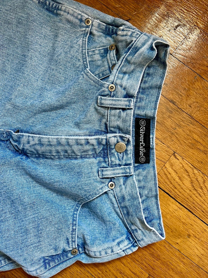 May include: Light blue denim shorts with a Silverlake label. The shorts have a faded look and are made of a soft, comfortable material.