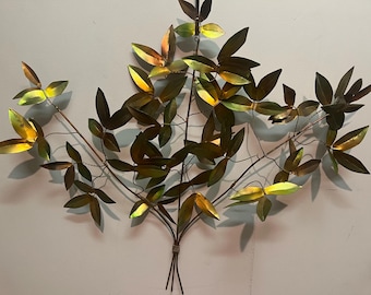 May include: A wall sculpture made of metal leaves in shades of gold and green. The leaves are arranged in a branching pattern, creating a realistic and organic look.