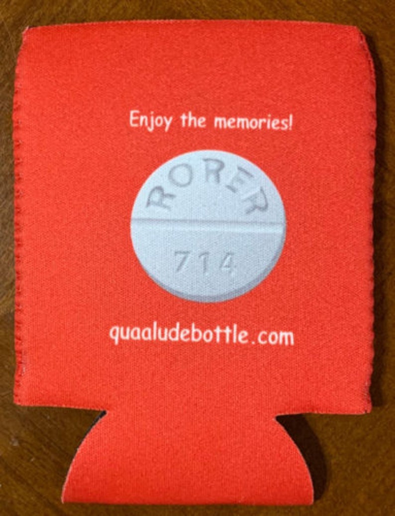May include: A red beverage can cooler with a white pill graphic in the center. The pill has the word "RORER" and the number "714" printed on it. The text "Enjoy the memories!" and "quaaludebottle.com" are also printed on the cooler.