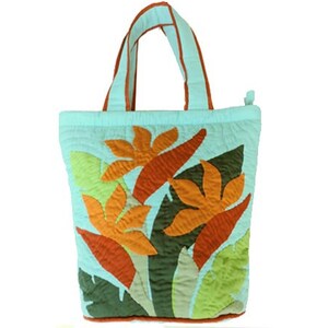 May include: A light blue quilted tote bag with orange and yellow floral applique. The bag has matching light blue handles with orange trim. The bag is approximately 12 inches wide and 14 inches tall.