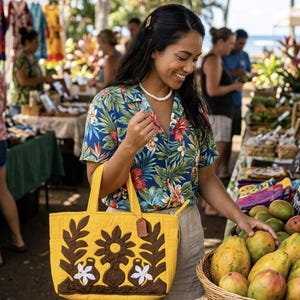 May include: A woman at a market holds a yellow tote bag with brown and white floral applique. She wears a floral shirt and shorts. The market has produce and other items for sale.