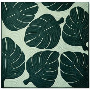 May include: A square quilt featuring a repeating pattern of large, dark green monstera leaves on a light green background. The leaves have detailed veining and are quilted with a swirling pattern. The quilt has a modern, botanical theme.