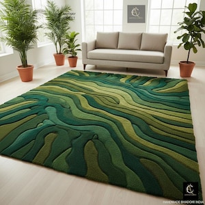 May include: A large, green area rug with a layered, topographic design. The rug features varying shades of green, creating a textured, three-dimensional effect. The rug is placed in a living room setting with a sofa and potted plants.