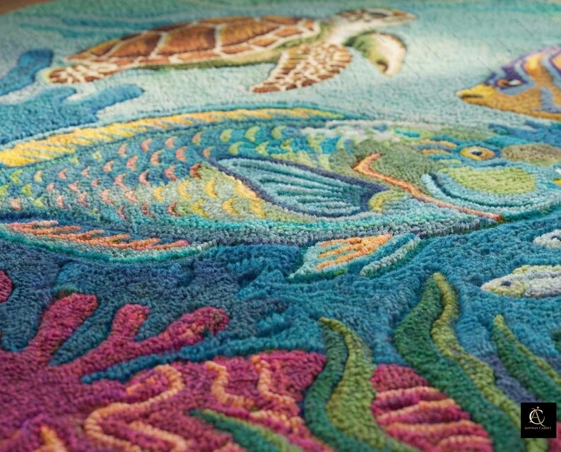 May include: A close-up of a colorful rug with an underwater scene. The rug features a sea turtle, fish, and coral in shades of blue, green, yellow, and pink. The design is detailed and textured, creating a vibrant ocean-themed decor.