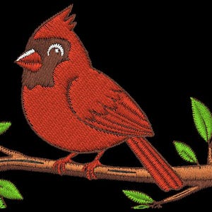 May include: Embroidered image of a red cardinal bird perched on a brown branch with green leaves. The bird has a brown head and a white beak. The background is black.