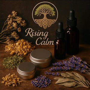 May include: An arrangement of apothecary items and botanicals. Two amber glass dropper bottles, two silver tins, and various dried herbs and flowers, including lavender and chamomile, are displayed on a wooden surface. The logo reads "Rising Calm".