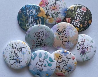 May include: Nine round floral patterned buttons with the text "Best life ever" in black lettering.