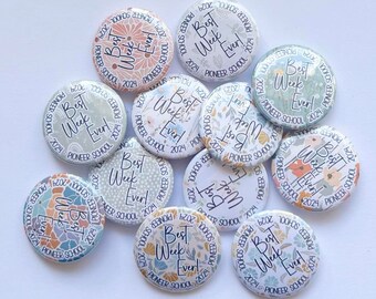 May include: A collection of 10 round, colorful buttons with the text "Best Week Ever!" and "Pioneer School 2024" printed on them. The buttons have a floral design with different colors and patterns.