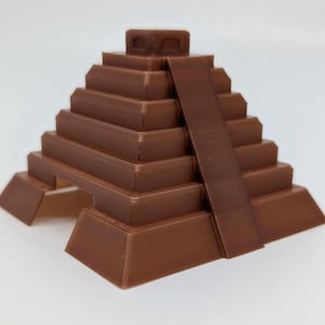 May include: A brown 3D printed model of a Mayan pyramid with a ramp leading to the top.