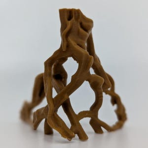 May include: A brown, 3D-printed sculpture of tree roots. The sculpture has a rough texture and intricate details, with multiple roots intertwining and forming a complex structure. The object is set against a plain white background.