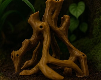 May include: A detailed, brown, artificial tree root structure, likely for terrarium or aquarium decoration. The root system has multiple branches and holes, with a naturalistic appearance. The background features green plants and moss, suggesting a natural environment.