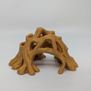 May include: A detailed, tan-colored miniature tree stump with an archway. The sculpture features intricate details of bark and branches, creating a naturalistic appearance. Ideal for miniature landscapes or dioramas.