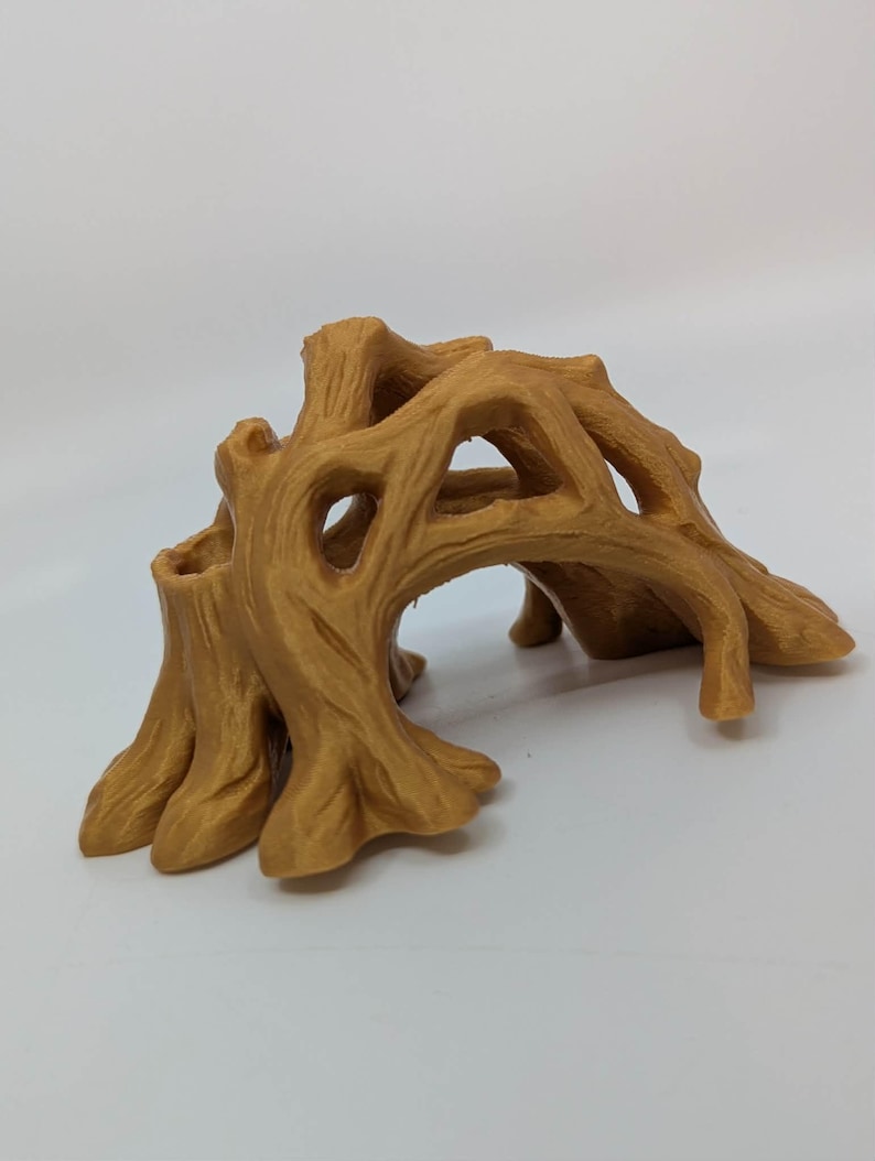 May include: A brown, stylized tree stump with multiple openings and a textured surface. The decorative piece has a natural wood grain appearance and is designed to resemble a small archway or tunnel. It is likely a decorative item for a terrarium or aquarium.