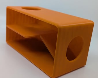 May include: Orange plastic storage box with two compartments and a circular opening on one side.