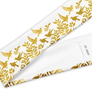 May include: White headband with a gold bird and floral pattern. The design features stylized birds and leaves in a repeating border. The ID #654 is printed on the headband. The headband is made of a soft, flexible material.
