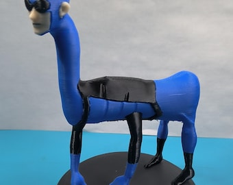 May include: A blue and black figurine of a creature with a human face wearing sunglasses and a beret. The figure has a long neck and is standing on a black circular base. The figure's body is blue, with black accents.