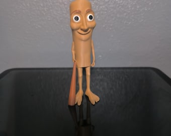 May include: A tan-colored, cartoonish figure with a smiling face, large eyes, and small arms and legs. The figure is holding a brown, cone-shaped object. The figure is standing on a reflective surface.