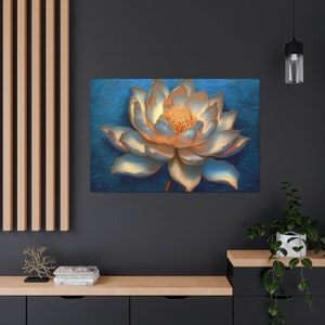 May include: A close-up of a white and gold lotus flower against a blue background. The flower is in full bloom and features a delicate, intricate design.