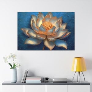 May include: A close-up of a white and gold lotus flower with a blue background. The flower is in focus and the background is blurred.