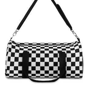 May include: Black and white checkered duffel bag with a black shoulder strap and two black handles.