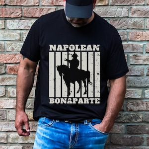 May include: Black t-shirt with a vintage-style graphic of Napoleon Bonaparte on horseback. The text "NAPOLEON BONAPARTE" is printed below the image.