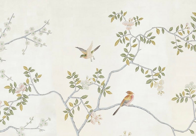 May include: A white background with a delicate floral pattern featuring green leaves and white flowers. Two birds are perched on the branches, one in flight and the other resting.