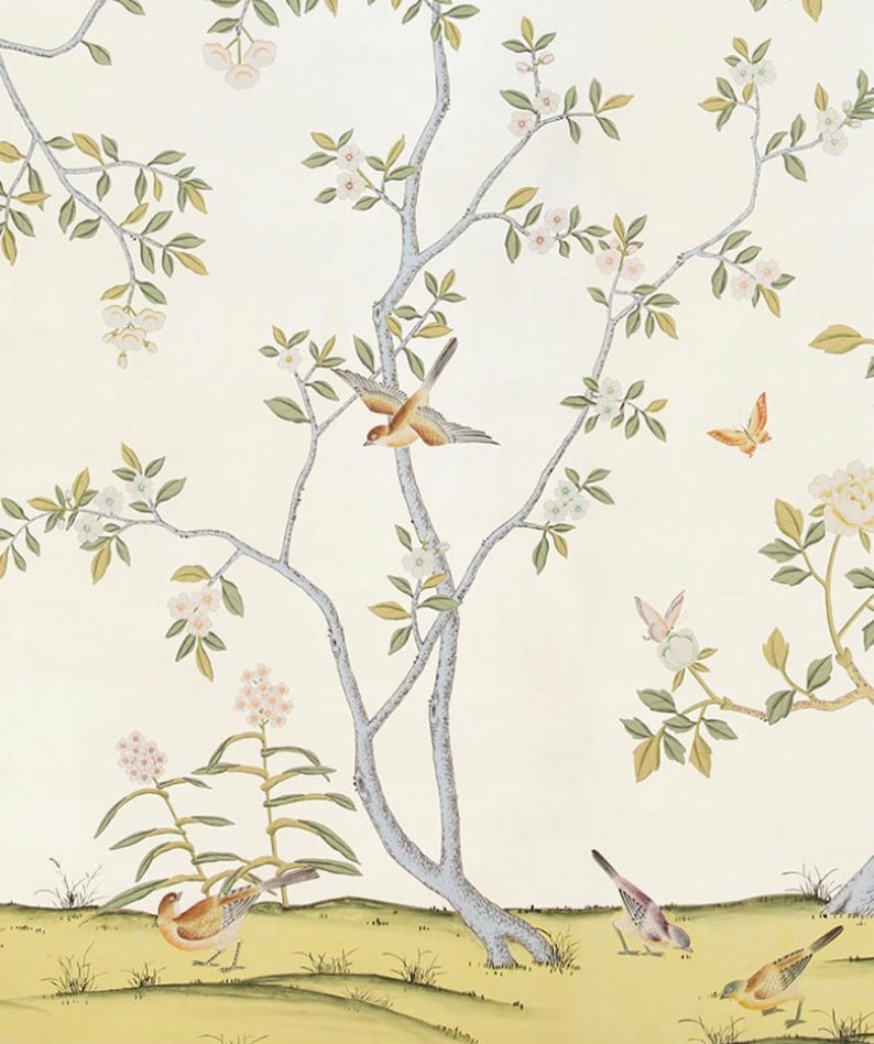 May include: A white background with a delicate floral pattern featuring a light blue tree with pink flowers and green leaves.  There are several small brown and yellow birds perched on the branches and flying around the tree.  There are also a few butterflies in the image.