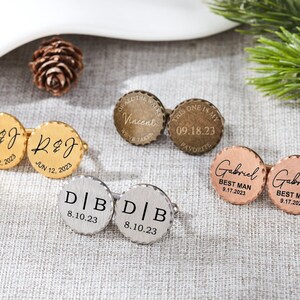May include: Set of six gold, silver, and rose gold cufflinks with engraved text. The cufflinks feature various dates and names, including "R&J Jun 12, 2023", "Vincent 09.18.23", "D|B 8.10.23", and "Gabriel Best Man 9.17.2023".