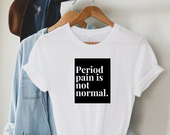 Puede incluir: Camiseta blanca con un gráfico cuadrado negro que dice "El dolor menstrual no es normal."
