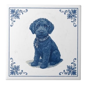 May include: A square ceramic tile featuring a blue illustration of a curly-haired dog with a patterned collar. The dog is centered on a white background, framed by blue floral corner designs and a blue border.