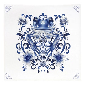 May include: A blue and white frog with intricate details sits in the center of a floral design. The frog is surrounded by stylized flowers and leaves, creating a decorative pattern.