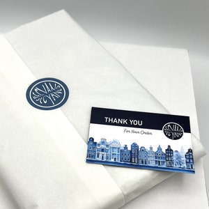 May include: A white tissue paper wrapping with a blue and white logo that says "Sevilla Cyan" and a thank you card with the same logo and the text "Thank You For Your Order".
