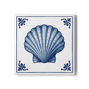 Może przedstawiać: Kwadratowa płytka ceramiczna z niebieskim wzorem muszli na białym tle. Płytka ma niebieską obwódkę i dekoracyjne akcenty w rogach. Muszla jest centralnym punktem, z szczegółowymi liniami.