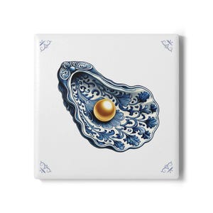 May include: Square ceramic tile featuring a blue and white oyster shell design with a gold pearl. The shell has intricate floral patterns. Decorative corner accents complete the design. A unique home decor item.