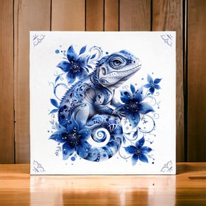 May include: A blue and white ceramic lizard with floral details. The lizard is sitting on a branch with flowers and leaves. The background is a white canvas.