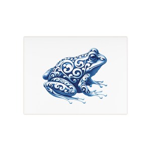 May include: A blue frog with a white swirling pattern on its skin. The frog is sitting on a white background.