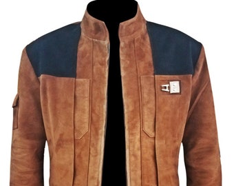 May include: A brown suede jacket featuring a stand-up collar, a central zipper closure, and contrasting black panels on the shoulders. The front includes vertical seam detailing, two chest pockets, and a metallic silver rectangular accent piece.