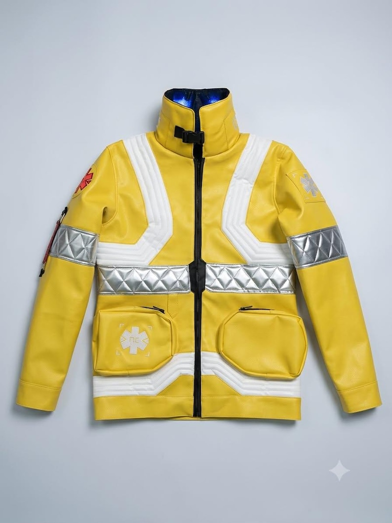 May include: A bright yellow jacket featuring a high collar with a black buckle, silver reflective quilted bands across the chest and sleeves, two front pockets, and red and white Star of Life emblems on the shoulder and chest area.