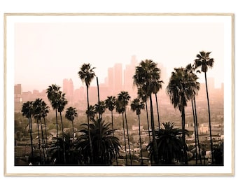 May include: A framed print featuring a sepia-toned cityscape with palm trees in the foreground. The tall, slender palm trees are silhouetted against a hazy skyline of buildings. The print has a light wood frame.
