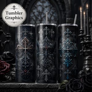 May include: Three cylindrical tumblers with metal straws, each featuring a dark, gothic-inspired design with intricate, ornate cross motifs in shades of black, grey, and blue. A circular logo in the top left corner displays the text Tumbler Graphics.