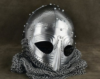 May include: A silver Viking helmet with a chainmail coif. The helmet has a hammered metal finish and a pointed nose guard.