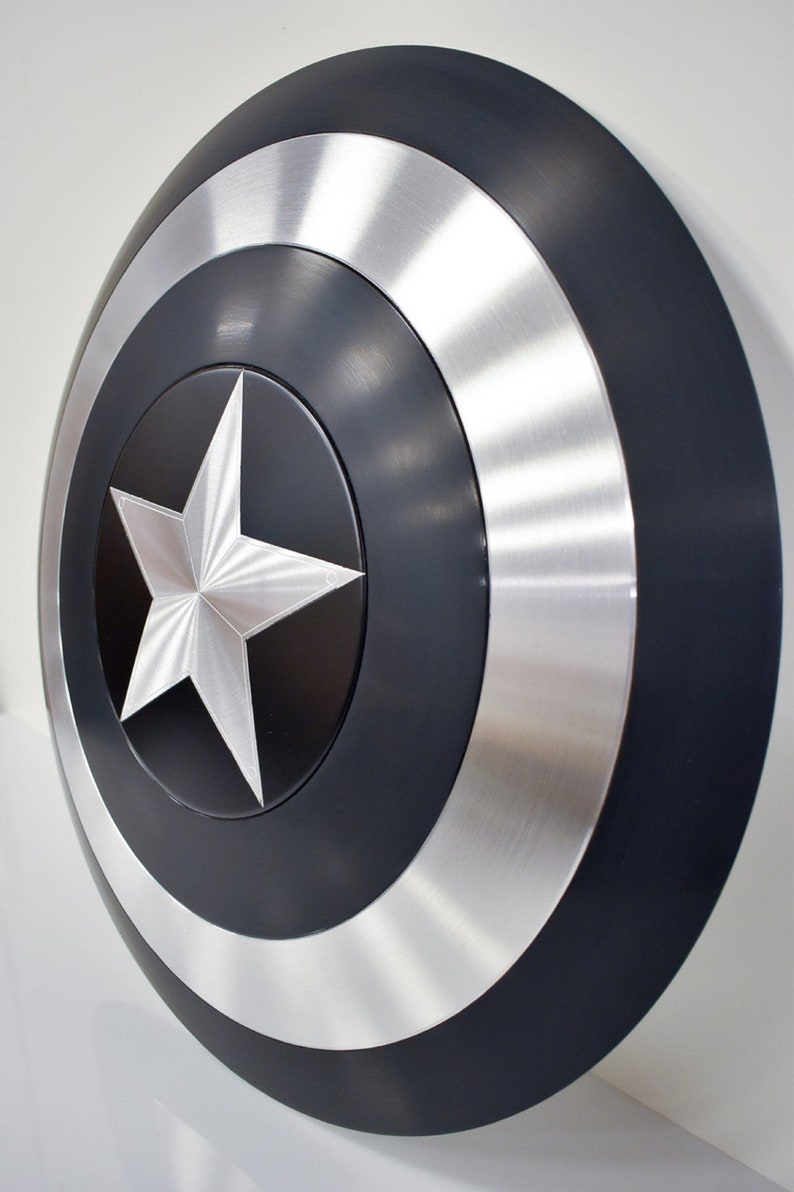 May include: A black and silver Captain America shield with a five-pointed star in the center.