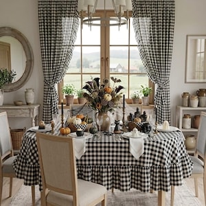 May include: A dining table set for a seasonal gathering, covered with a black and white gingham tablecloth featuring a ruffled edge. The table is decorated with a centerpiece of dried flowers, small pumpkins, and various ghost-shaped figurines.